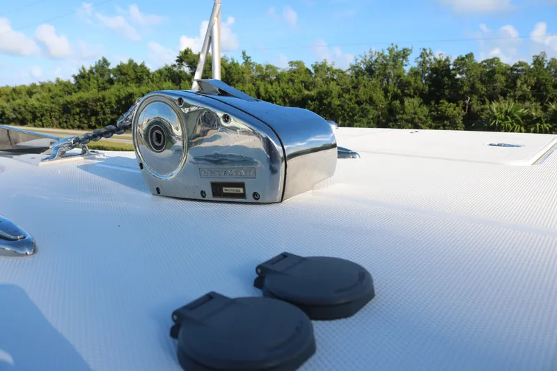 Slide: The Image of 2024 World Cat 325 CC boat deck with anchor winch and clear sky. - 12