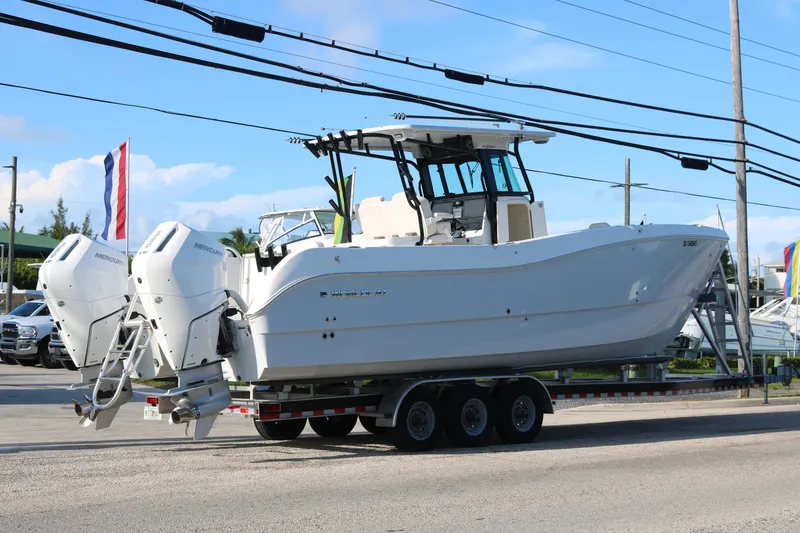 Slide: The Image of 2024 World Cat 325 CC boat on trailer with dual Mercury engines. - 3