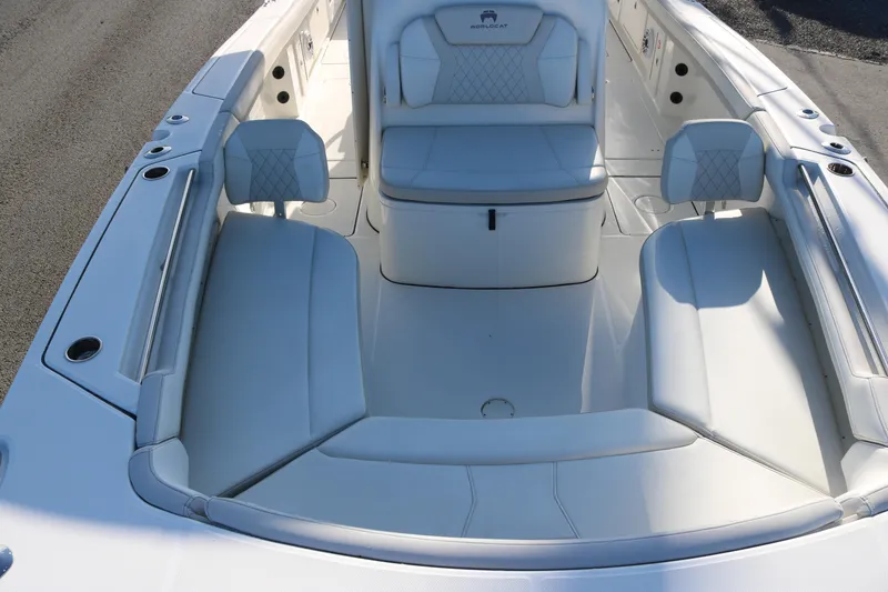 Slide: The Image of 2024 World Cat 325 CC boat interior with white cushioned seating and sleek design. - 6
