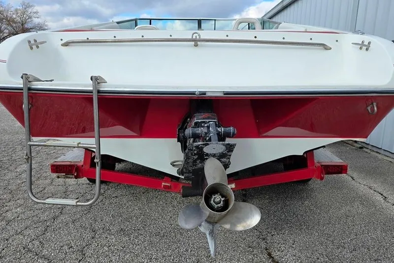 Slide: The Image of 1991 Rinker 236 Captiva Cuddy Cabin boat rear view with propeller and ladder. - 12