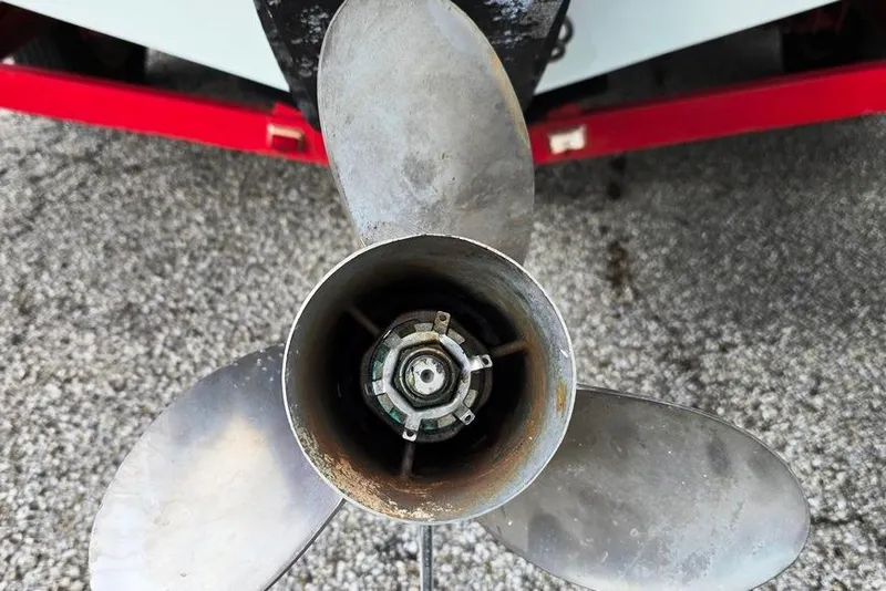 Slide: The Image of Propeller of 1991 Rinker 236 Captiva Cuddy Cabin on gravel surface. - 14