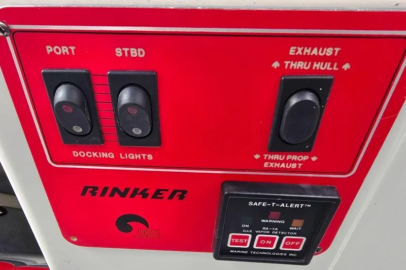 Slide: The Image of Control panel of a 1991 Rinker 236 Captiva Cuddy Cabin boat with docking light switches. - 20