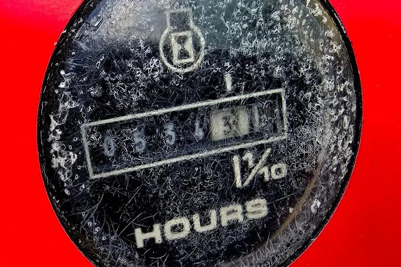 Slide: The Image of Close-up of a weathered hour meter on a 1991 Rinker 236 Captiva Cuddy Cabin. - 21