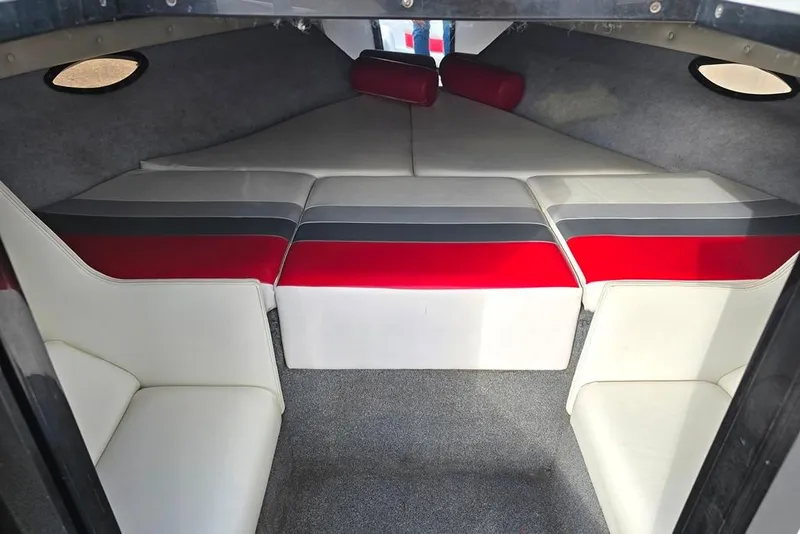 Slide: The Image of 1991 Rinker 236 Captiva Cuddy Cabin interior with red and gray seating. - 6
