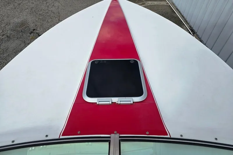 Slide: The Image of 1991 Rinker 236 Captiva Cuddy Cabin boat with red and white deck design. - 9