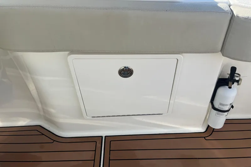 Slide: The Image of 2021 Boston Whaler 240 Vantage boat with cushioned seating, cruising on open water. - 11