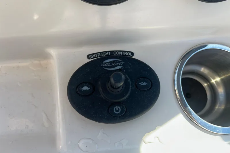 Slide: The Image of 2021 Boston Whaler 240 Vantage boat interior with storage compartment and fire extinguisher. - 14