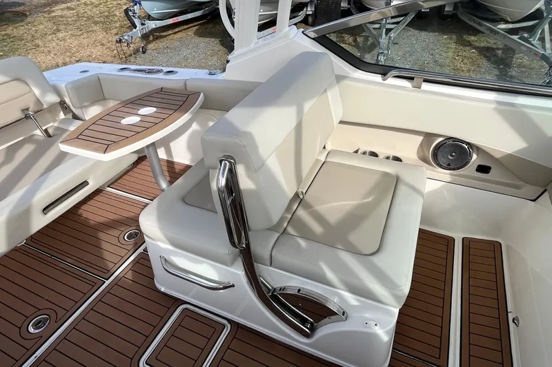 Slide: The Image of Interior of 2021 Boston Whaler 240 Vantage boat with seating and wooden table. - 18