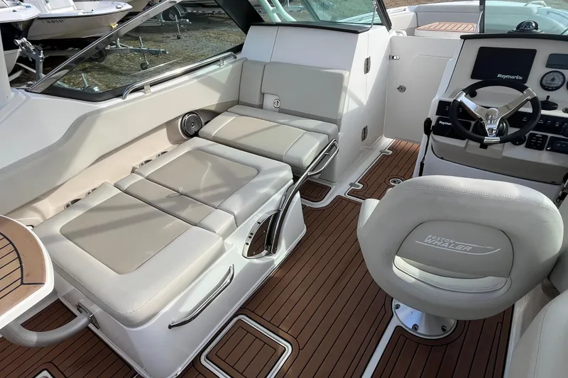 Slide: The Image of Interior of 2021 Boston Whaler 240 Vantage boat with cushioned seating and wood flooring. - 19