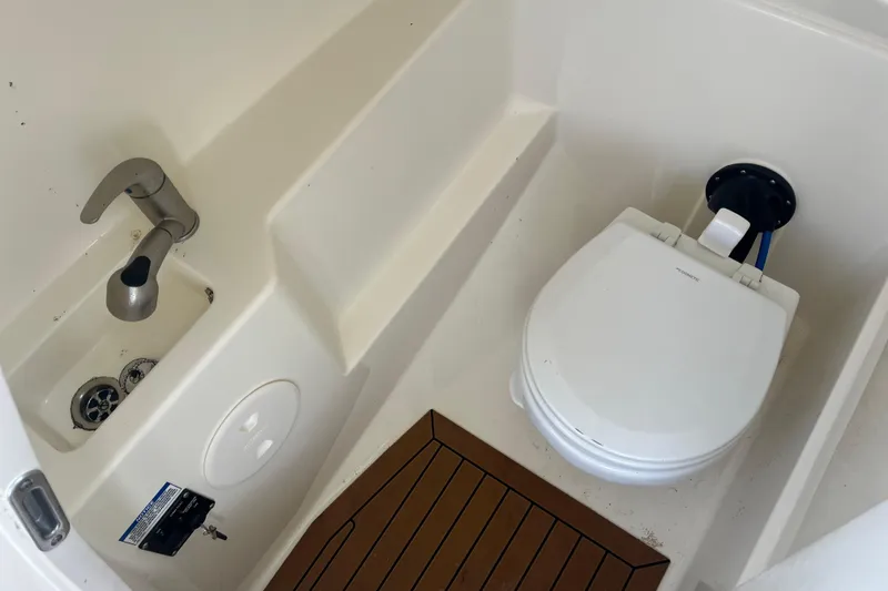 Slide: The Image of 2021 Boston Whaler 240 Vantage interior with seating and teak flooring. - 20