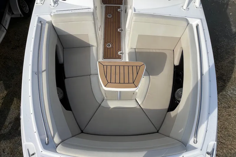 Slide: The Image of 2021 Boston Whaler 240 Vantage interior with cushioned seating and wooden flooring. - 21