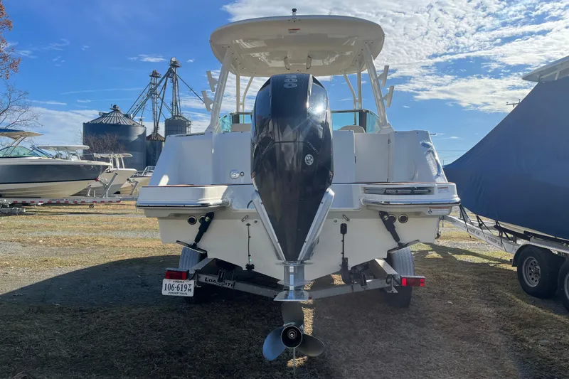 Slide: The Image of 2021 Boston Whaler 240 Vantage boat on trailer, parked outdoors under clear blue sky. - 38