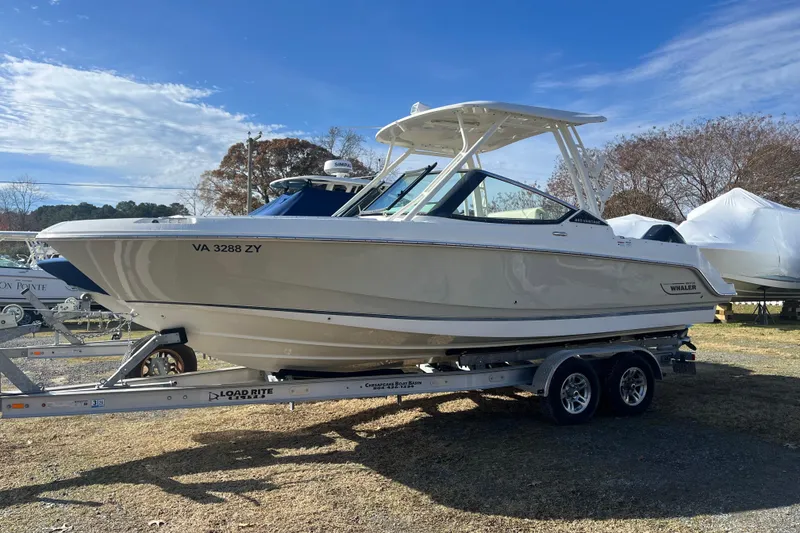 Slide: The Image of 2021 Boston Whaler 240 Vantage boat on trailer, parked outdoors under clear sky. - 39