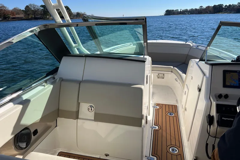Slide: The Image of 2021 Boston Whaler 240 Vantage boat interior with seating and navigation system on a sunny day. - 43