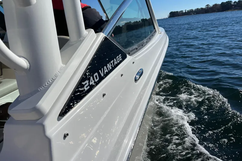 Slide: The Image of 2021 Boston Whaler 240 Vantage cruising on open water, side view. - 45