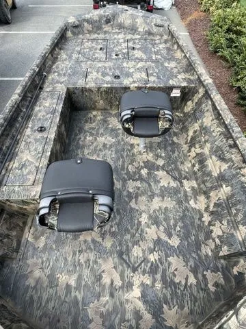 Slide: The Image of 2023 Crestliner 1760 Retriever Jon Deluxe boat with camouflage design and two seats. - 3