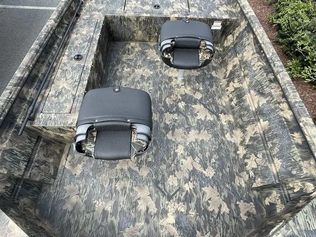 Slide: The Image of 2023 Crestliner 1760 Retriever Jon Deluxe boat with camouflage interior and two seats. - 4