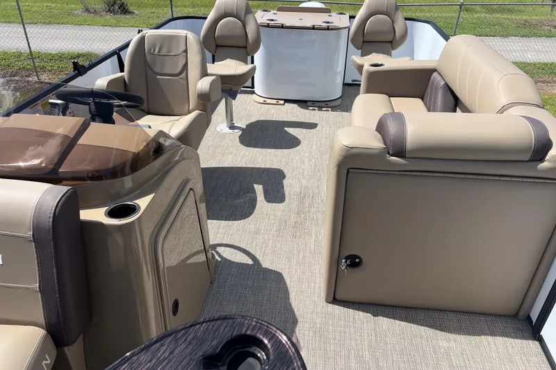 Slide: The Image of 2026 Sylvan Mirage Fish 820 Party Fish interior with beige seating and steering console. - 11