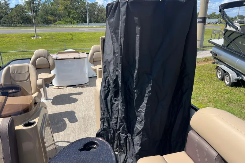 Slide: The Image of 2026 Sylvan Mirage Fish 820 Party Fish boat interior with seating and privacy curtain. - 12
