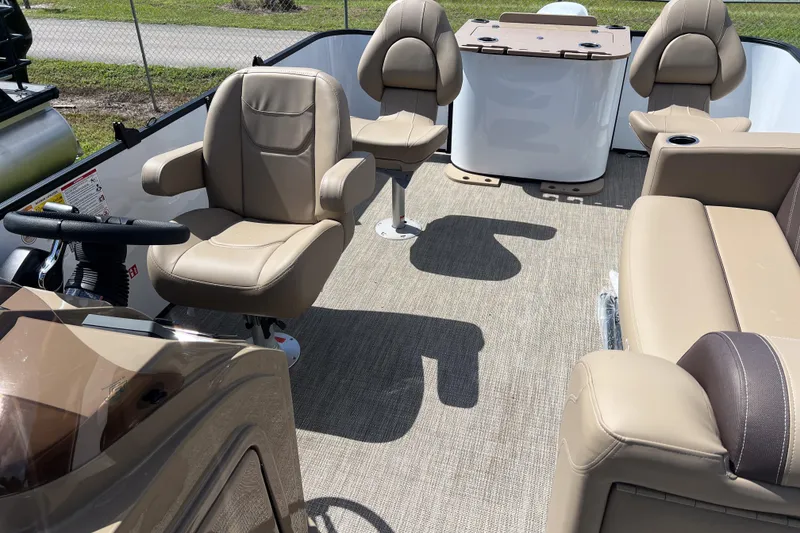 Slide: The Image of 2026 Sylvan Mirage Fish 820 Party Fish boat interior with beige seating and steering console. - 13