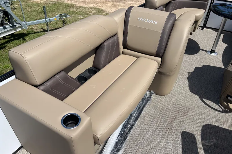 Slide: The Image of 2026 Sylvan Mirage Fish 820 Party Fish boat seating with cup holders and beige upholstery. - 17