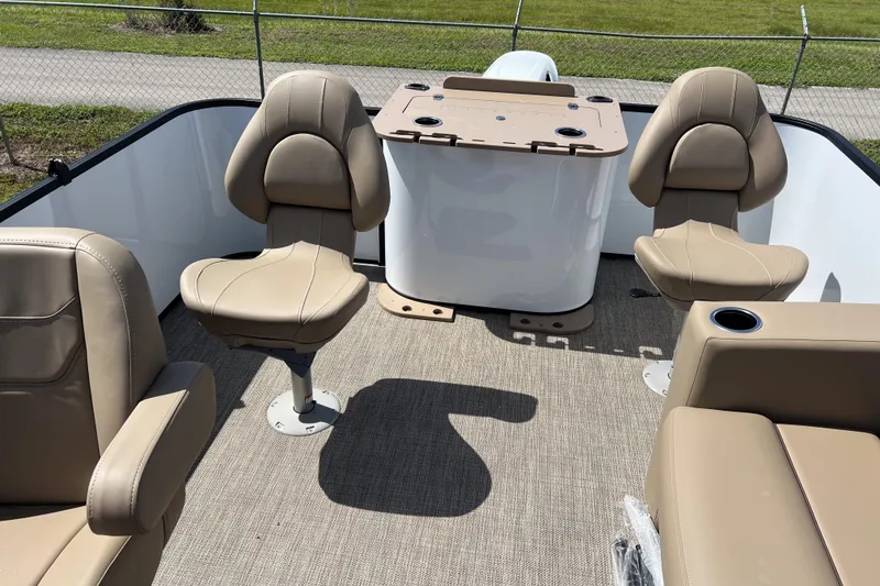 Slide: The Image of 2026 Sylvan Mirage Fish 820 Party Fish boat interior with beige seating and fishing station. - 18