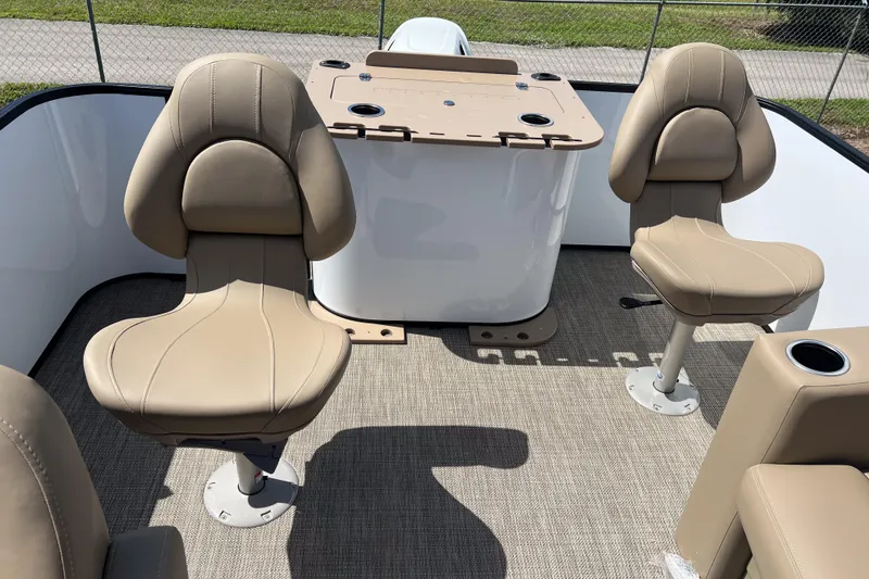 Slide: The Image of 2026 Sylvan Mirage Fish 820 Party Fish boat interior with beige seating and fishing station. - 19