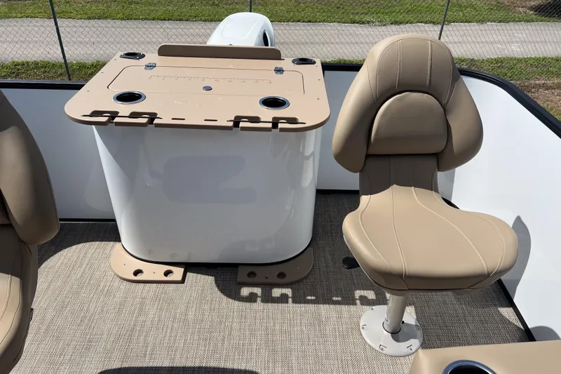 Slide: The Image of 2026 Sylvan Mirage Fish 820 Party Fish boat interior with beige seating and fishing station. - 20