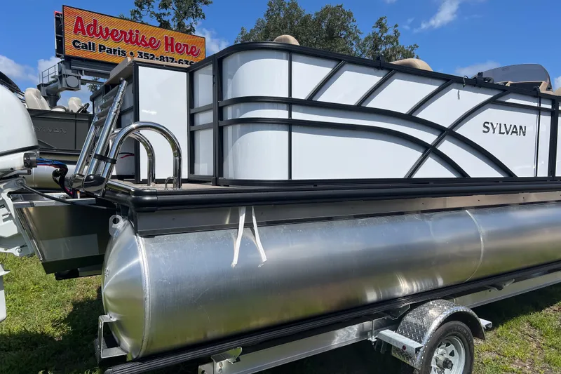 Slide: The Image of 2026 Sylvan Mirage Fish 820 Party Fish pontoon boat on trailer, sunny day. - 3