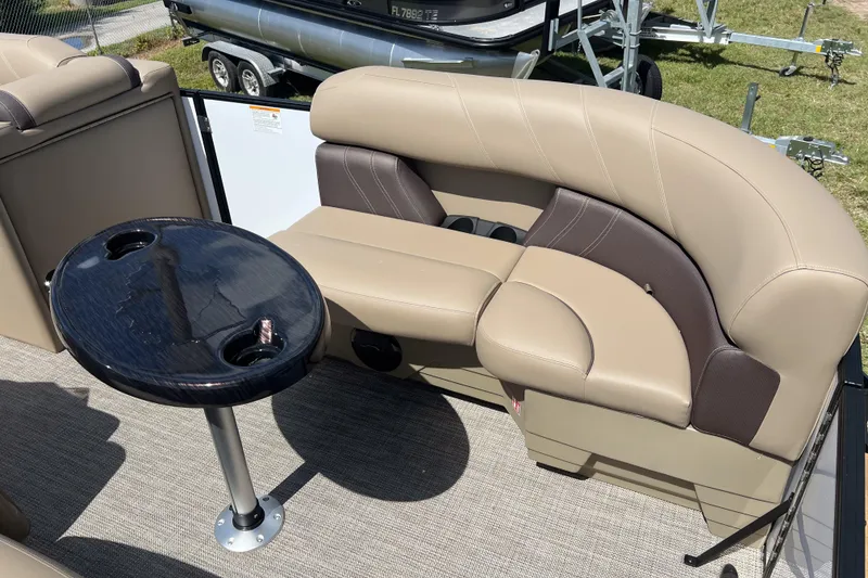 Slide: The Image of 2026 Sylvan Mirage Fish 820 Party Fish boat interior with beige seating and round table. - 9