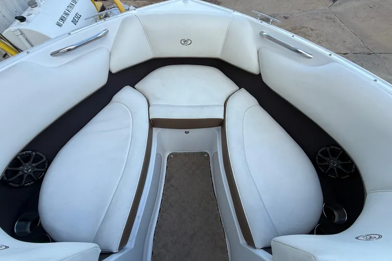 Slide: The Image of Interior of a 2015 Cobalt 200 boat with white cushioned seating. - 11