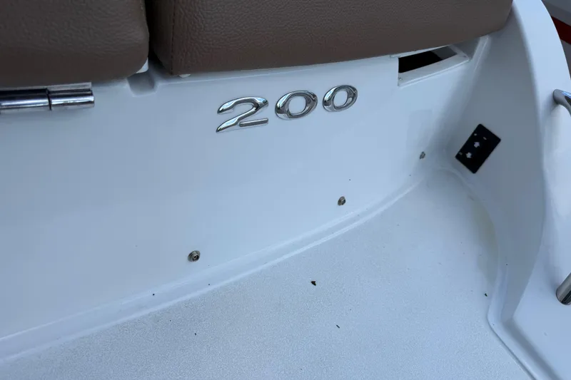 Slide: The Image of 2015 Cobalt 200 boat interior with brown seating and model emblem. - 23