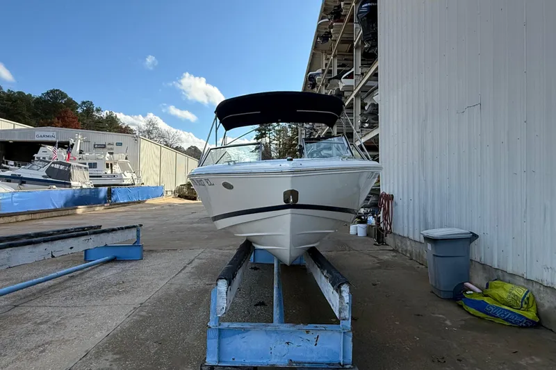 Slide: The Image of 2015 Cobalt 200 boat on trailer, parked outdoors under a clear blue sky. - 5