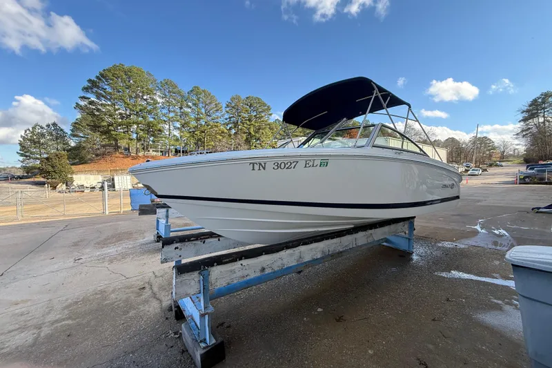 Slide: The Image of 2015 Cobalt 200 boat interior with white seating and steering wheel, docked at marina. - 6