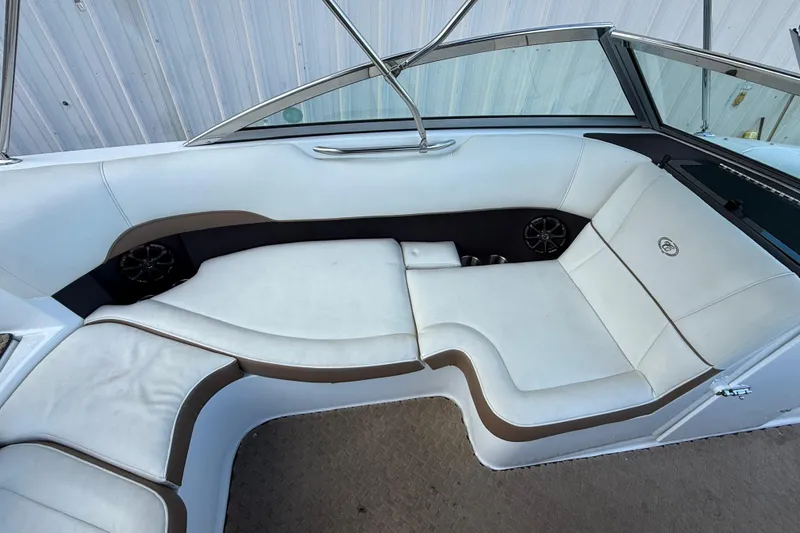 Slide: The Image of 2015 Cobalt 200 boat interior with white and brown seating, featuring built-in speakers. - 9