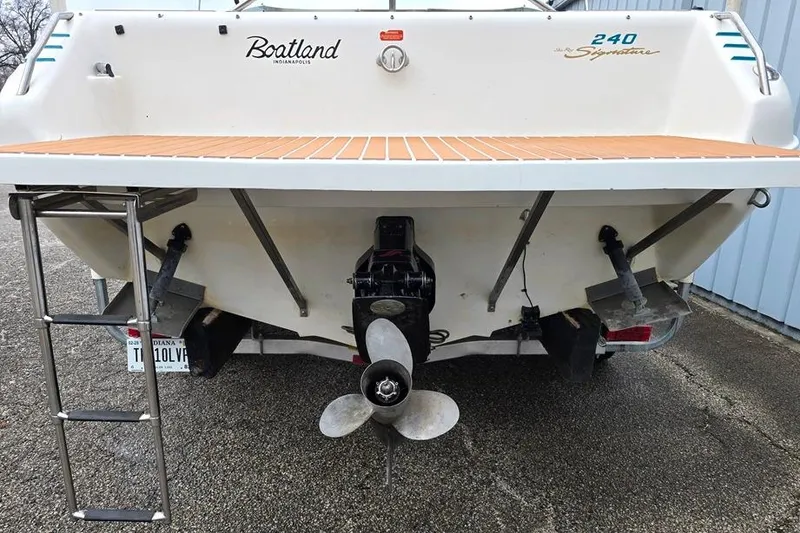 Slide: The Image of 1995 Sea Ray 240 Bow Rider boat stern with propeller and swim platform. - 12