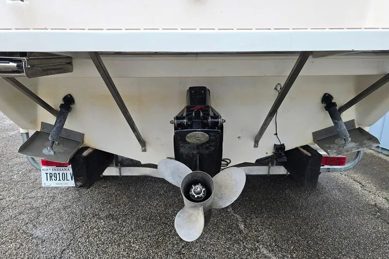 Slide: The Image of 1995 Sea Ray 240 Bow Rider boat stern with propeller and Indiana license plate. - 13