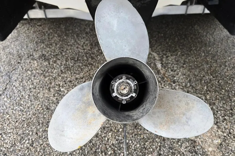 Slide: The Image of Propeller of 1995 Sea Ray 240 Bow Rider on gravel surface. - 15