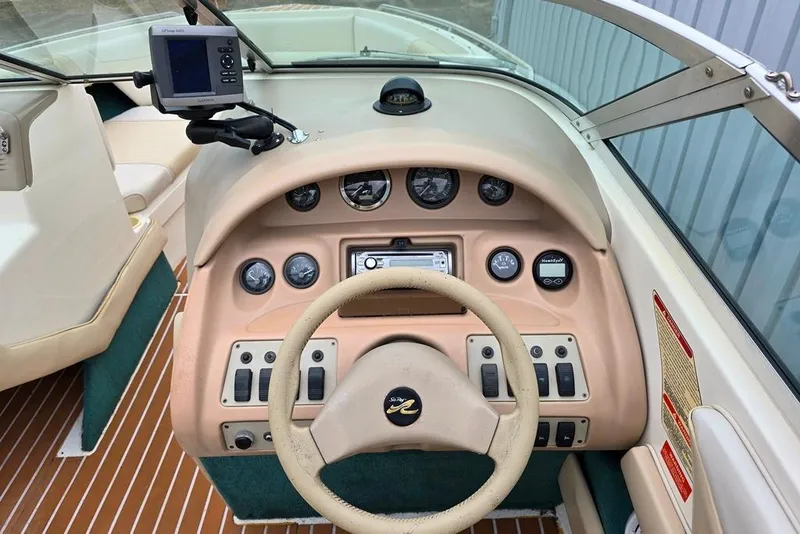 Slide: The Image of 1995 Sea Ray 240 Bow Rider dashboard with steering wheel and instrument panel. - 20