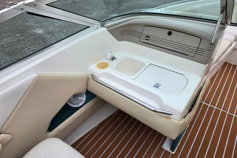 Slide: The Image of 1995 Sea Ray 240 Bow Rider interior with seating and storage compartments. - 7