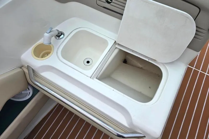 Slide: The Image of Sink and storage on 1995 Sea Ray 240 Bow Rider. - 8