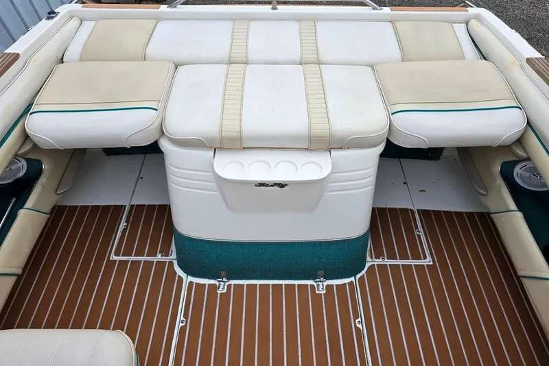 Slide: The Image of 1995 Sea Ray 240 Bow Rider interior with cushioned seating and striped flooring. - 9