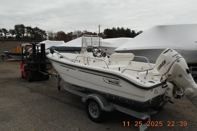 Slide: The Image of 2001 Boston Whaler 16 Dauntless boat on trailer, outdoor storage area. - 7