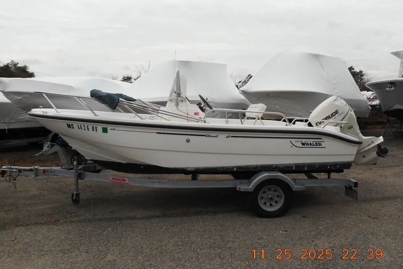 Slide: The Image of 2001 Boston Whaler 16 Dauntless boat on trailer, parked outdoors. - 8