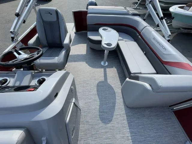 Slide: The Image of 2023 Bennington 20 SXL pontoon boat interior with gray seating and a central table. - 7