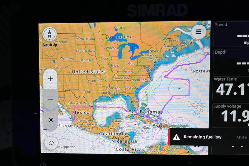 Slide: The Image of Simrad navigation display on Viaggio X 22S Tritoon, showing map and fuel alert. - 13