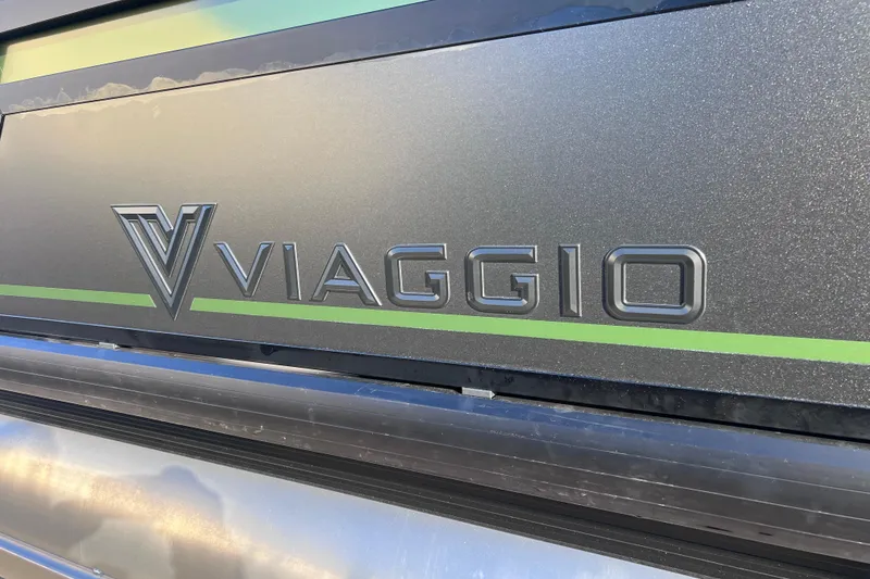 Slide: The Image of Viaggio X 22S Tritoon 2026 logo on sleek metallic surface with green accent. - 2