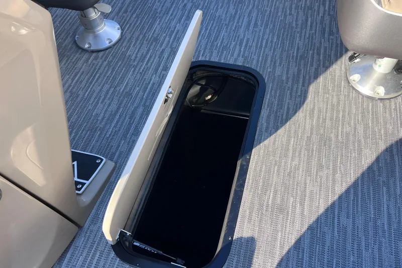 Slide: The Image of Open storage compartment on 2026 Viaggio X 22S Tritoon boat deck. - 33