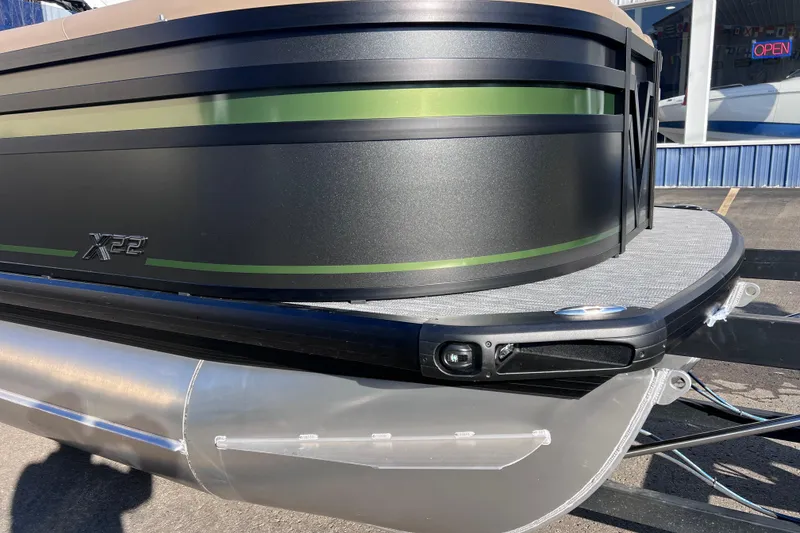 Slide: The Image of 2026 Viaggio X 22S Tritoon boat with sleek black and green design. - 5