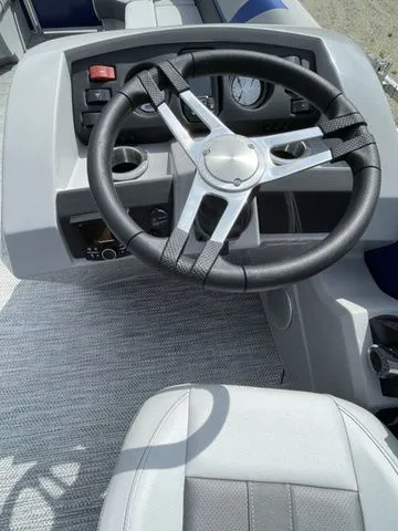 Slide: The Image of Steering wheel of 2023 Bennington 20 SXL boat, featuring modern dashboard controls. - 5